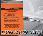A photo of a parking ticket on a car for information on how to pay a City parking ticket.