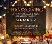 A fall scene with pumpkins, candles, and lights to announce City closings for Thanksgiving.