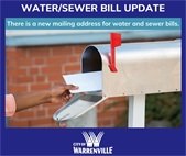 A photo of someone putting a bill in a mailbox to promote the new mailing address for water and sewer bills.