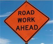 A photo of a road work sign because the county has begun work on Warrenville and Naperville roads.