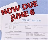 A photo of a utility bill with "now due June 6" stamped across it.