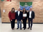 A photo of Warrenville Mayor David Brummel, City Administrator Cristina White and Community Unit School District 200 Superintendent Jeff Schuler with a high school student.