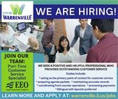 A photo of employees providing customer service at a desk.