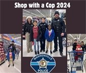 A photo of Warrenville police with two local children who got to Shop with a Cop for the holidays.