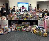Warrenville police pose with piles of toys that residents generously donated for the Toys for Tots Program.