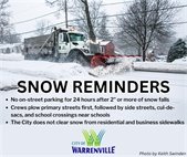 A photo of a snow plow removing snow from a street.