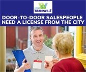 A door-to-door salesman talking to a woman at her front door.